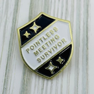 May include: A shield-shaped enamel pin with a gold border. The pin is divided into black and white sections, with the text "POINTLESS MEETING SURVIVOR" in gold. Gold starburst designs are on the black sections.