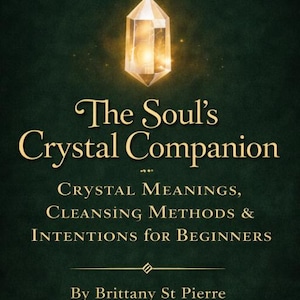 May include: Book cover with a dark green background, a gold crescent moon, and a glowing crystal. The title reads "The Soul's Crystal Companion" with text about crystal meanings and cleansing methods. Author: Brittany St Pierre.