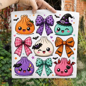 Peut inclure: Une surface en tissu blanc avec un motif répétitif de boulettes et de nœuds de style dessin animé. Les boulettes ont des visages expressifs, certaines portent des chapeaux de sorcière ou des ailes de chauve-souris. Les nœuds sont décorés.