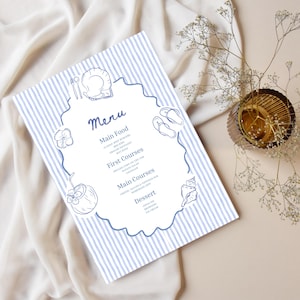May include: A rectangular menu card featuring a light blue and white vertical striped background. The center has a white scalloped frame containing the text Menu, Main Food, First Courses, Main Courses, and Dessert, with blue line art illustrations of a plate, cutlery, flip-flops, a coconut drink, a flower, and a seashell.