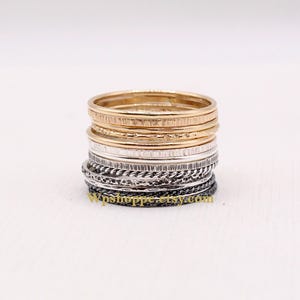 Thin stackable rings in a set of 13. Mixed metal bands of sterling silver and gold filled.