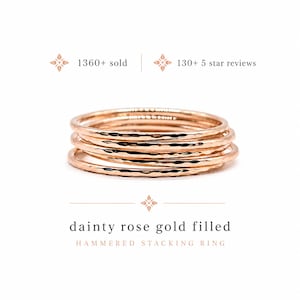 May include: A stack of rose gold filled hammered stacking rings. The rings have a textured surface and are displayed on a white background. The text "dainty rose gold filled" and "hammered stacking ring" is below the rings.
