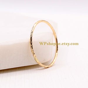 Simple gold wedding ring. Delicate hammered gold filled stacking ring. Sold individually or in sets.