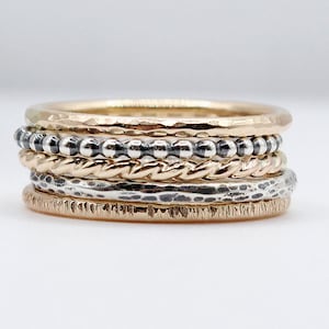 Set of 5 14k mixed metal stacking rings. Layered 14k gold filled and sterling silver bands in different textures. WPshoppe jewelry.