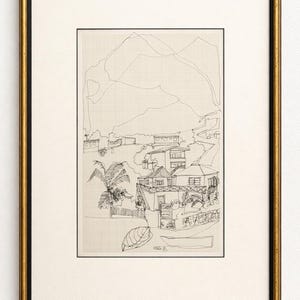 May include: Black and gold framed art print featuring a detailed pen and ink drawing of a coastal landscape. The artwork depicts buildings, palm trees, and a mountain range, all rendered in fine lines on a grid background.