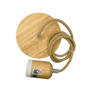 May include: A wooden pendant light fitting with a circular, light-coloured wooden ceiling plate and a matching cylindrical lamp holder. The cord is a twisted, natural-coloured rope. The lamp holder has a white base.