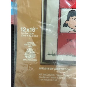 May include: A needlepoint kit package labeled 8110/018 MY GENERATION with a finished size of 12x16 inches. The packaging features a graphic of a character with black hair and includes Persian crewel wool yarn made of 100% pure wool.