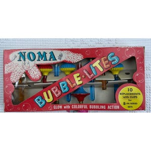 May include: A rectangular red cardboard box containing Noma Bubble Lites replacement bulbs. The box features the text Noma Bubble Lites, Glow with Colorful Bubbling Action, and 10 Replacements with Clips for 8-in-series sets. The bulbs have colorful bases.