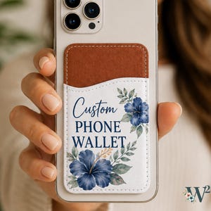 May include: A light-colored smartphone with a two-tone adhesive wallet attached to the back. The wallet features a brown top section and a white bottom section with blue hibiscus flowers and the text Custom PHONE WALLET in blue script.