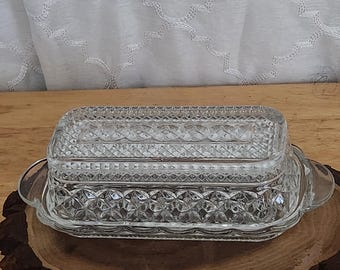 VIntage Anchor Hocking Wexford butter dish made of clear pressed glass with a diamond pattern.