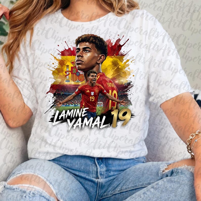 May include: A white t-shirt featuring a graphic print of soccer player Lamine Yamal. The design includes a portrait and a full-body action shot of the player in a red and yellow jersey, set against a Spanish flag background with the text Lamine Yamal 19.