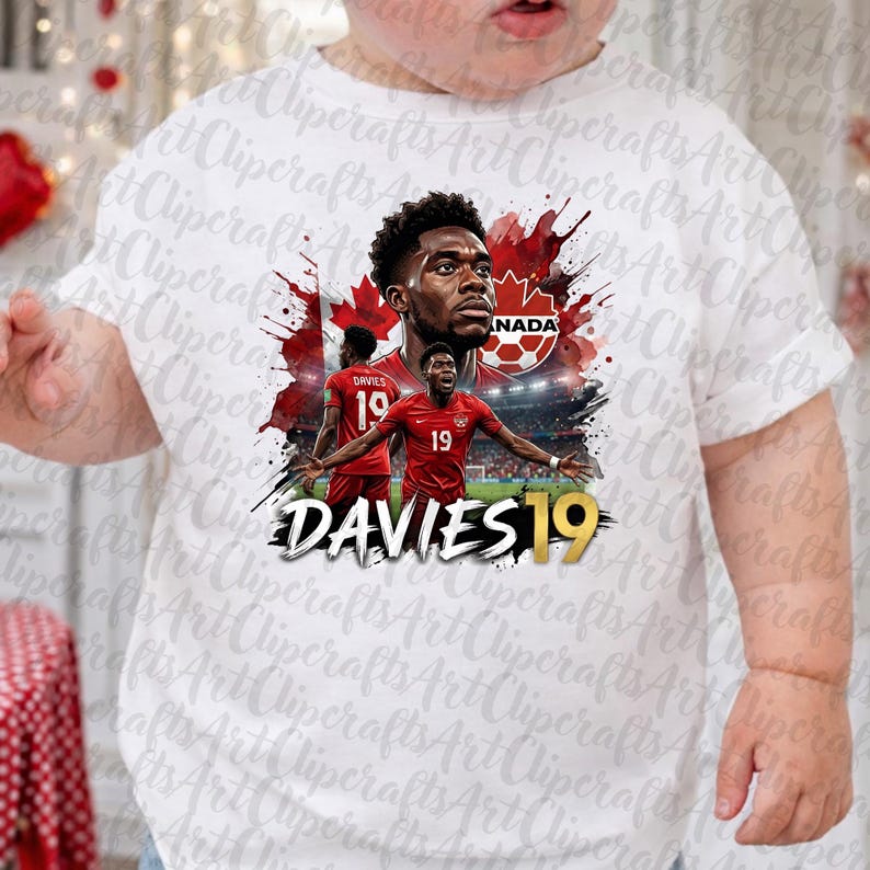 May include: A white t-shirt featuring a graphic of soccer player Alphonso Davies in a red jersey with the number 19. The design includes a red maple leaf, a soccer ball icon, the text CANADA, and the name DAVIES 19 in bold white and gold lettering.