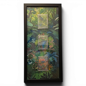 May include: A framed artwork featuring three illustrated cards set against a jungle backdrop. The cards depict scenes of lush greenery and vibrant flowers. The frame is black, and the artwork is displayed vertically.