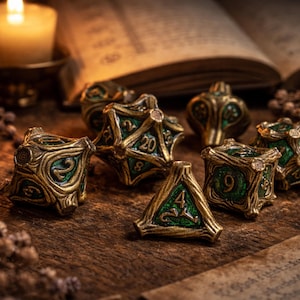 May include: A set of polyhedral dice featuring a metallic gold finish with a textured, branch-like exterior and deep green enamel inlays. The dice display various numbers, including a prominent 20 on the twenty-sided die and a 4 on the four-sided die.