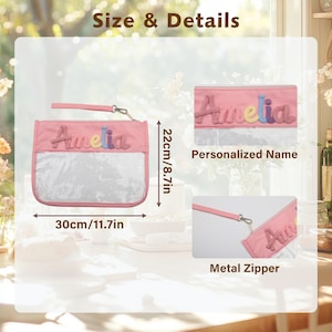 May include: A pink rectangular pouch with a clear front panel and a wrist strap. The name Amelia is appliqued in multi-colored letters. Dimensions are 11.7 inches by 8.7 inches. The pouch features a metal zipper and personalized name detailing.