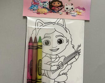 May include: A coloring activity set featuring a black and white line art illustration of a character with cat ears playing a guitar. The set includes three Crayola crayons in pink, brown, and green, packaged with a header card showing colorful characters.