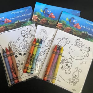 May include: Party favor sets featuring coloring pages and crayons. Each set includes a coloring page with sea creatures and a pack of crayons. The sets are topped with a card that reads "Thank you for coming to Edwin's 3rd birthday!"