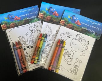 May include: Party favor sets featuring coloring pages and crayons. Each set includes a coloring page with sea creatures and a pack of crayons. The sets are topped with a card that reads "Thank you for coming to Edwin's 3rd birthday!"