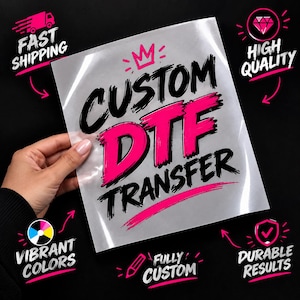 May include: A clear sheet featuring the text CUSTOM DTF TRANSFER in bold black and bright pink brushstroke lettering with a small pink crown icon above. Surrounding text includes FAST SHIPPING, HIGH QUALITY, VIBRANT COLORS, FULLY CUSTOM, and DURABLE RESULTS.