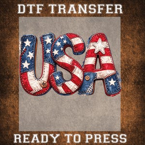 May include: DTF TRANSFER and READY TO PRESS text above and below the word "USA". The letters are designed with a patchwork of red, white, and blue fabric, featuring stars and stripes. The background is a textured, brown color.