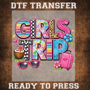 May include: DTF TRANSFER design with the words "GIRLS TRIP" in colorful, patterned letters. The design includes a pink suitcase, sunglasses, a coconut drink, and flowers. The text "READY TO PRESS" is also included.
