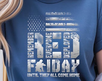 May include: Navy blue t-shirt with a distressed American flag design. The shirt features the words "REMEMBER EVERYONE DEPLOYED RED FRIDAY" and "UNTIL THEY ALL COME HOME" in a distressed, silver font.