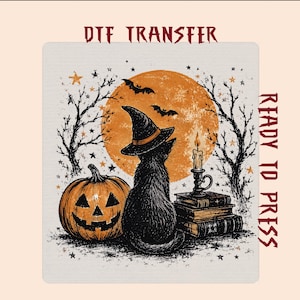 May include: A DTF transfer sheet featuring a black cat wearing a witch hat, sitting beside a jack-o'-lantern and a stack of books with a lit candle. The background shows a large orange moon, bare trees, and bats. Text reads DTF TRANSFER READY TO PRESS.