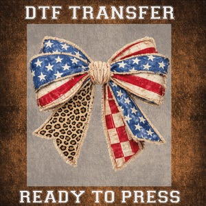 May include: A DTF transfer featuring a large bow design. The bow incorporates elements of the American flag with red and white stripes, blue fields with white stars, and a leopard print pattern. The text "DTF TRANSFER" and "READY TO PRESS" are displayed.