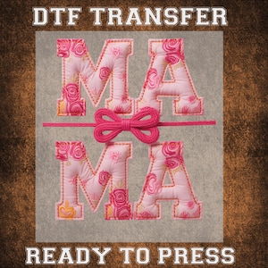 May include: A DTF transfer featuring the word "MAMA" in pink, floral-patterned letters with orange stitching. A pink bow and string are centered between the two words. The text "READY TO PRESS" is at the bottom, and "DTF TRANSFER" is at the top.