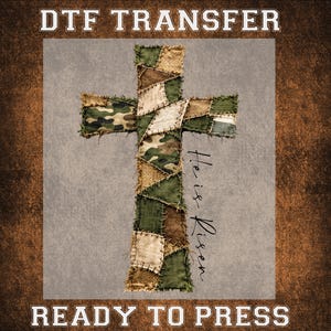 May include: A cross-shaped DTF transfer design. The cross is constructed from patches of camouflage, burlap, and green fabric. The words "He is Risen" are written vertically on the right side of the cross. The words "DTF TRANSFER" and "READY TO PRESS" are at the top and bottom.