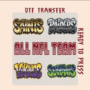 May include: A DTF transfer sheet featuring the text "DTF TRANSFER" and "READY TO PRESS" in red. The sheet displays four NFL team names in stylized fonts: "SAINTS" in gold, "RAIDERS" in silver, "VIKINGS" in purple and yellow, and "SEAHAWKS" in green.