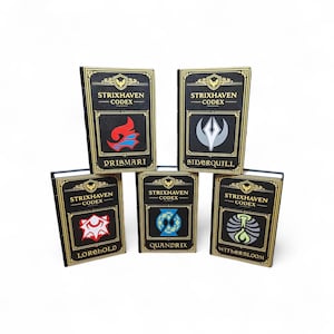 May include: Five black and gold Strixhaven Codex books are displayed. Each book features a different symbol and the name of a college: Prismari, Silverquill, Lorehold, Quandrix, and Witherbloom. The books have gold trim and white text.