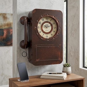May include: A vintage-style wall clock shaped like a telephone, with a rusty brown finish. The clock face is circular with Roman numerals and the word "Paris". The clock has a handset and a small rectangular panel below the clock face.