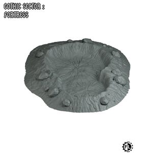 May include: A gray, fortress-shaped terrain piece with a crater-like center and rocky protrusions. The text "GOTHIC SECTOR : FORTRESS" is at the top. The piece is designed for tabletop gaming.
