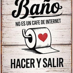May include: A rectangular metal sign with a distressed white wood background. The sign has black text that reads "- ESTO ES UN - Baño NO ES UN CAFE DE INTERNET HACER Y SALIR." A roll of toilet paper with a red heart is in the center.