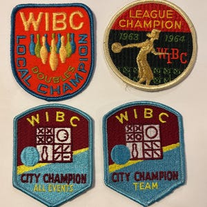 May include: A collection of embroidered patches with bowling themes. The patches feature text such as "WIBC", "Local Doubles Champion", "League Champion 1963-1964", and "City Champion". Colors include red, blue, gold, and teal.