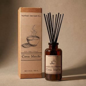 May include: A brown glass reed diffuser bottle with black reeds and a matching box. The box and bottle label read "Citrus Matcha" and "Northern Element Co." The box also states "Net 4 fl oz / 118 ml". The box has a drawing of a bowl with steam.