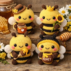 May include: Four handmade crochet bee figurines. Each bee is yellow with black stripes, brown accents, and white wings. One bee wears a hat and holds a honey pot. Another wears a crown and holds a sunflower. The other two hold honey dippers and honey pots.
