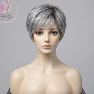 May include: A set of three ceramic mugs with a speckled, matte finish. The mugs are in shades of cream, light gray, and dark gray. Each mug has a simple, minimalist design, perfect for coffee or tea.