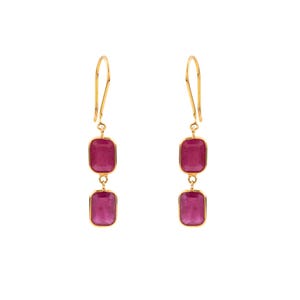 May include: A pair of gold drop earrings, each featuring two rectangular, deep pink gemstones set in a bezel frame. The earrings hang from a curved gold wire hook, with the two stones connected by a small gold link, creating a vertical design.