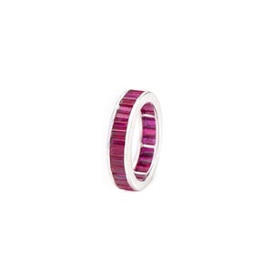 May include: A silver-toned eternity band ring featuring a continuous row of rectangular, baguette-cut deep pinkish-red gemstones set side-by-side around the entire circumference of the metal band, creating a vibrant and uniform circular design.