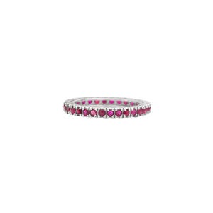 May include: A silver-toned eternity band ring featuring a continuous row of small, round, vibrant pinkish-red gemstones set closely together along the entire circumference of the metal band, creating a uniform and circular jewelry design.