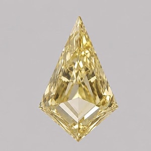 May include: A kite-shaped yellow gemstone with a brilliant cut, featuring numerous triangular and trapezoidal facets that create a complex, reflective surface. The stone has a sharp pointed top and bottom with a symmetrical geometric structure.