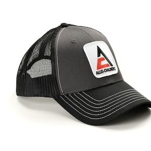 May include: A gray and black trucker hat with a black mesh back. The hat has a white patch with a red and black logo that says "Allis-Chalmers".