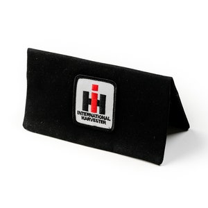May include: Black fabric wallet with a red and white International Harvester logo.