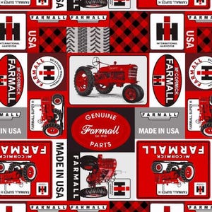 May include: A patterned fabric featuring red Farmall tractors, the Farmall logo, and the text Genuine Farmall Parts Est. 1923. The design includes black and red buffalo plaid squares, tire tread patterns, and the text Made in USA on a gray background.