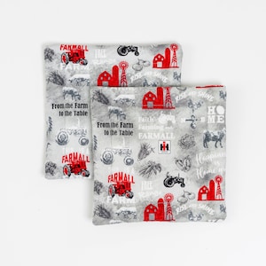 May include: Two gray fabric squares with a farmhouse theme. The fabric features a red tractor, a red barn, and the text "From the Farm to the Table" and "Faith Farming and FARMALL".