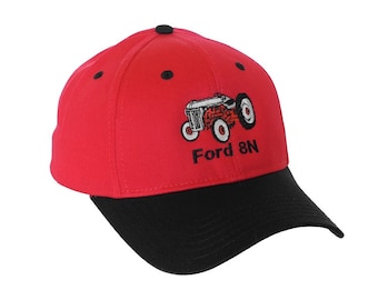 Puede incluir: Gorra de béisbol roja con visera negra. La parte delantera de la gorra tiene una imagen bordada de un tractor Ford 8N rojo y el texto "Ford 8N".