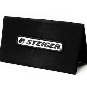 May include: A black canvas pouch with a white logo that says "STEIGER" in a rectangular shape.