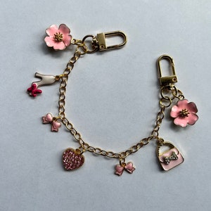 Purse charm with pink accessories